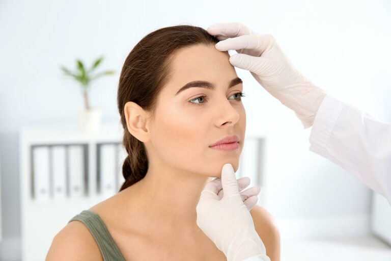 Dermatologist examining patients face in clinic Gateway ENT St Louis MO