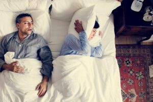 Couple in the bed man snoring woman unable to sleep